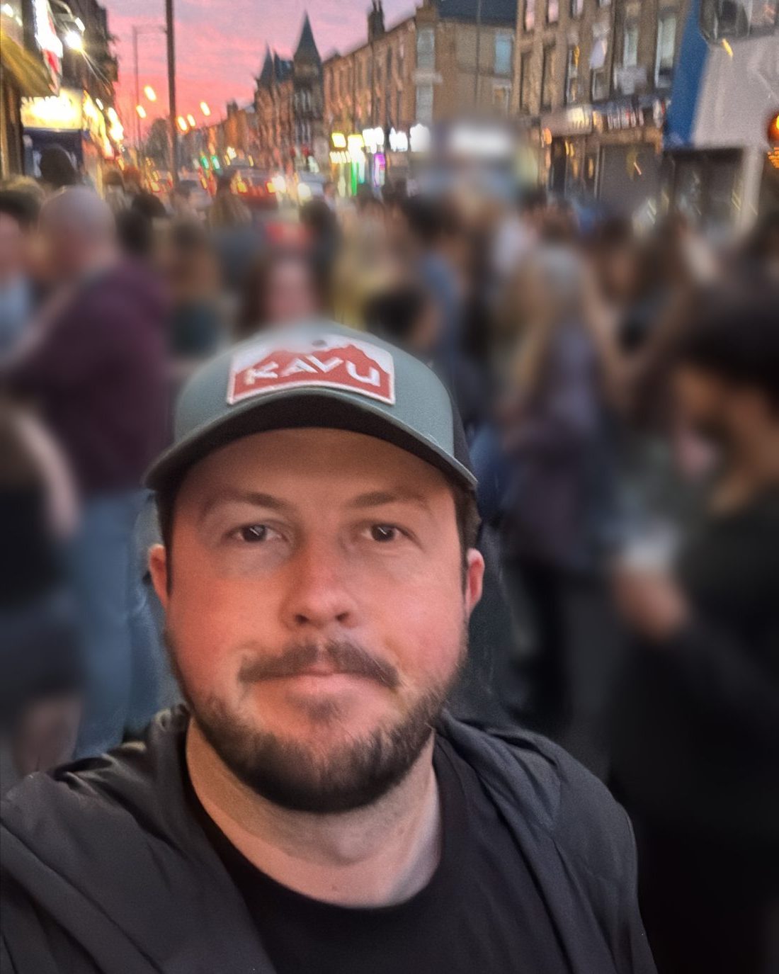 Josh Owens on a busy Liverpool street at sunset